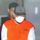 Tahanan KPK (koruptor) menggunakan masker dan topi saat digiring petugas usai pemeriksaan di Gedung Merah Putih KPK, Jakarta.